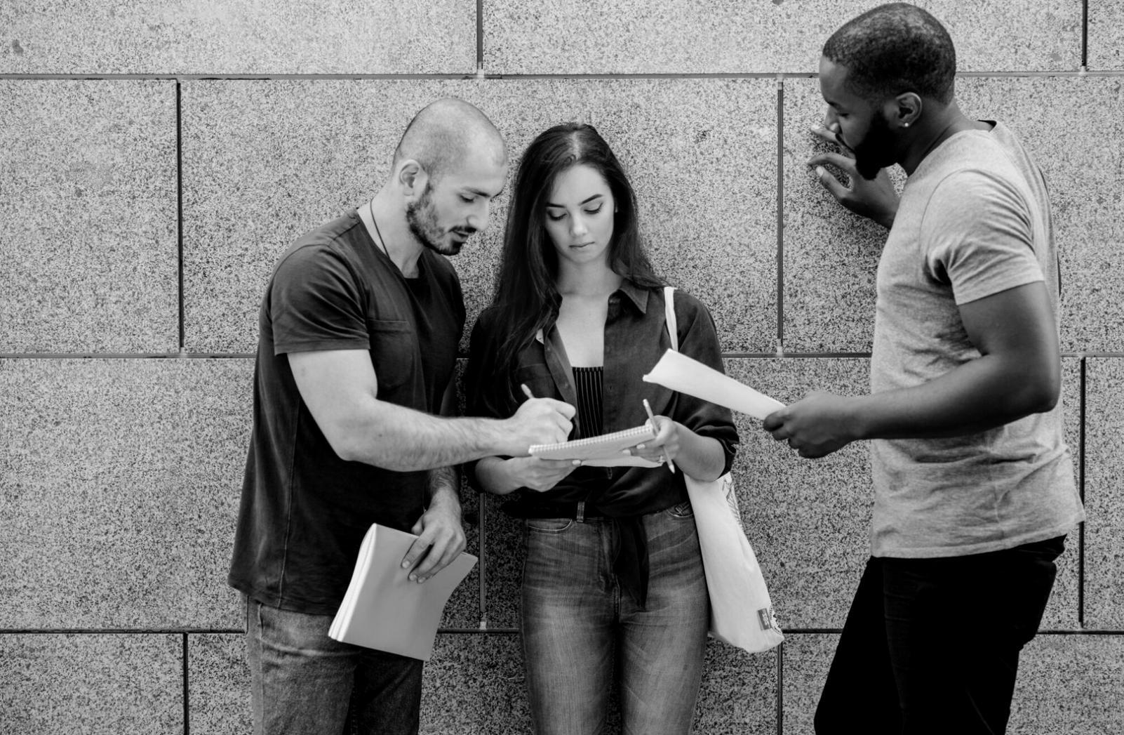 Financial consultation meeting with documents and charts spread across a conference table