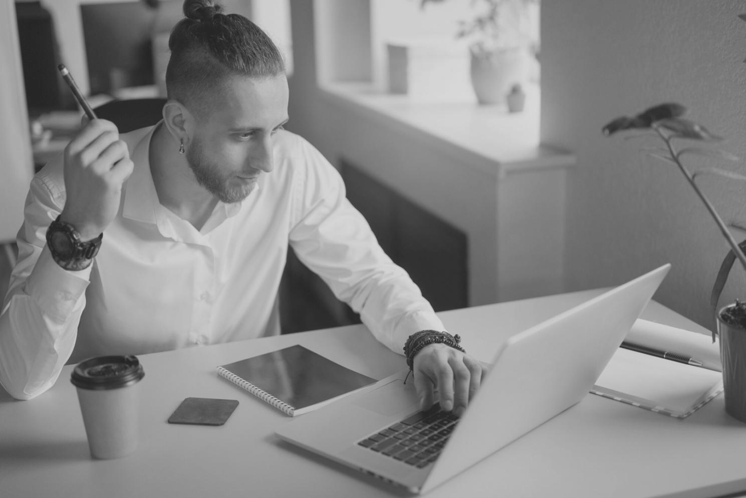 Financial analysis charts and strategic planning documents spread across desk