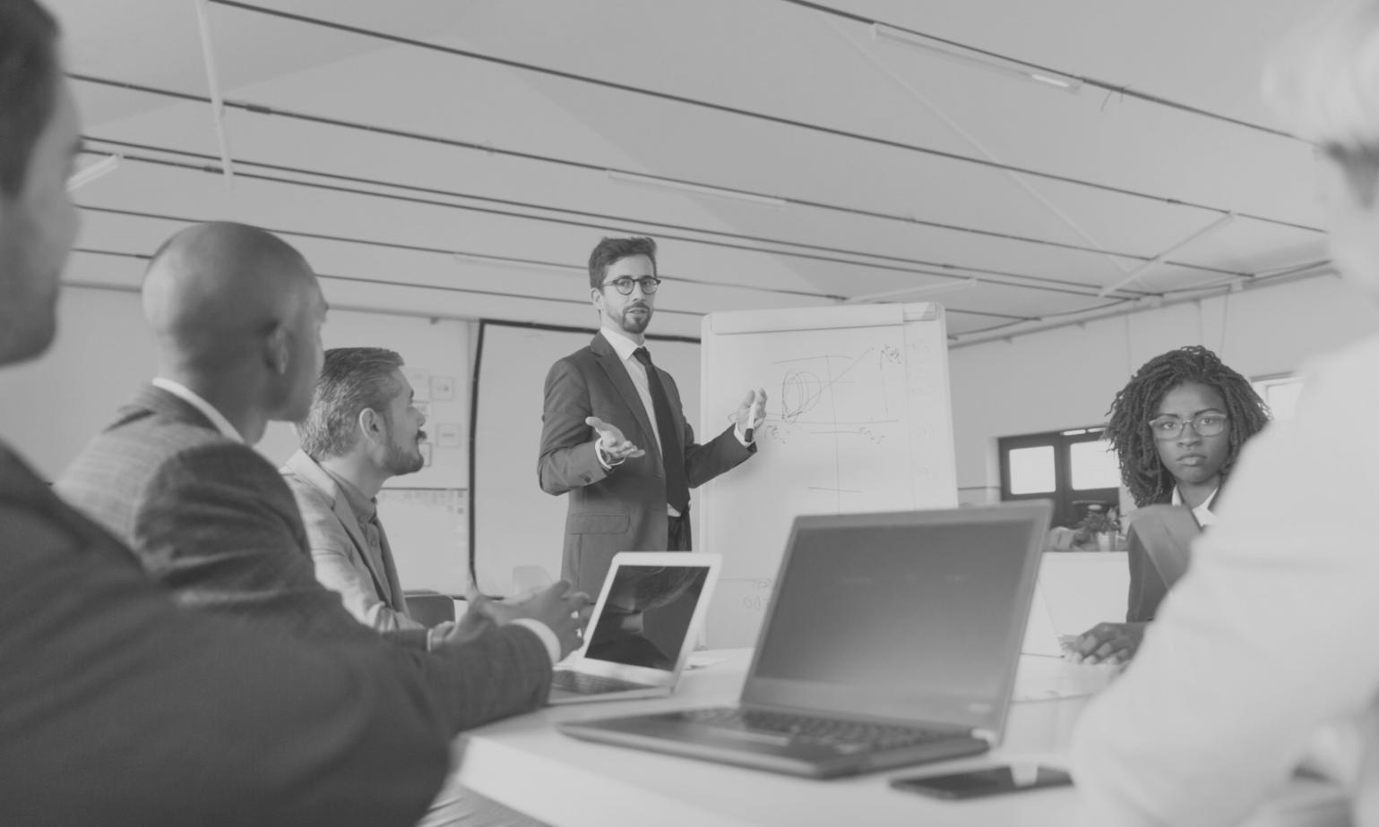 Business team reviewing financial documents and discussing budget strategies during training session